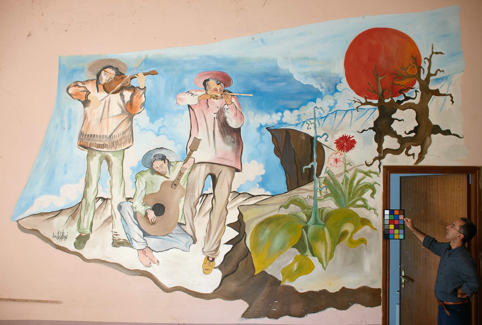 Three musicians, violin and guitar, under a great red sun.