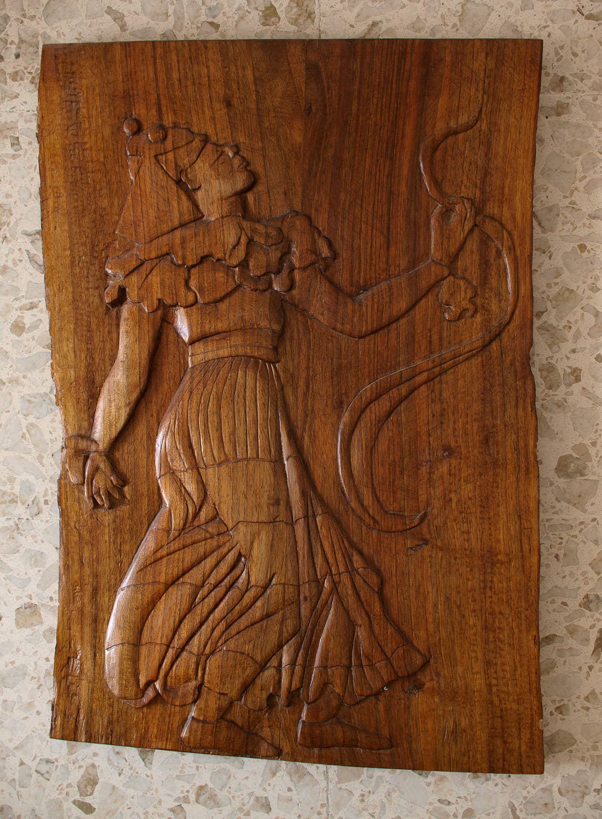 A dancer in costume, carved in wood.
