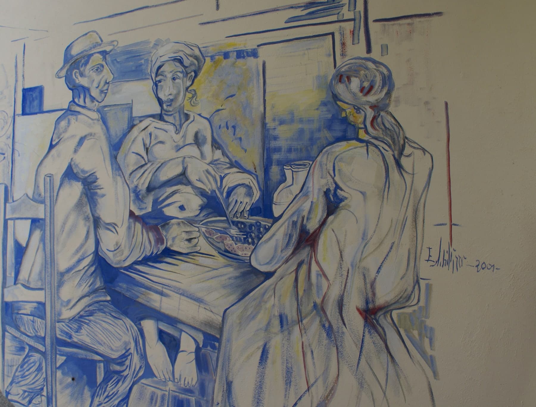 Disegnato in blu sul muro: tre figure attorno a un tavolo. Firmato «E. Schillizzi 2001». A Francavilla sul Sinni.